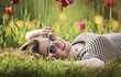 The girl lies on a bed with tulips