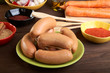 Sausages with spices and vegetables on an wooden table Sausages with spices and vegetables on an wooden table