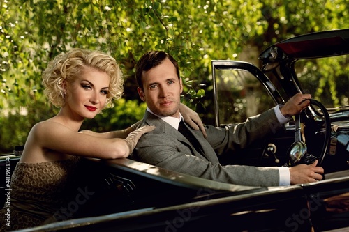 Photo: Retro couple in convertible Retro couple in convertible