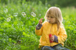 Adorable baby blow soap bubbles in park