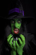 Witch holding her crystal ball, dark background.