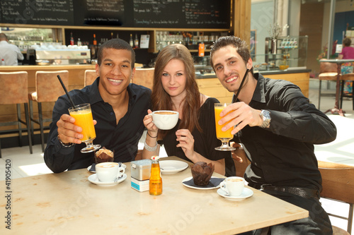 Photo: clinking glasses - friends in a coffee bar clinking glasses - friends in a coffee bar