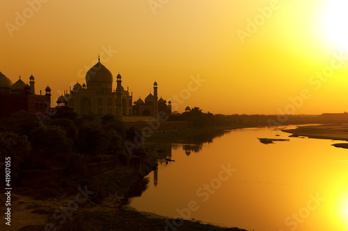 Fototapeta Taj Mahal with the Yamuna River at sunset, India.