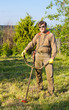 man with a lawn-mower in a garden
