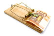 Mousetrap and money on a white background.