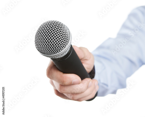 Photo: Male hand holding microphone for the interview Male hand holding microphone for the interview
