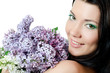 Beautiful woman with spring flowers of a lilac. Skincare