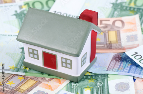 Photo: toy house for euro banknotes as a background toy house for euro banknotes as a background