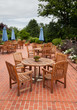 Teak patio tables and chairs on brick deck