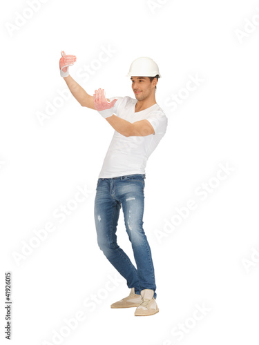 Photo: handsome builder in helmet handsome builder in helmet