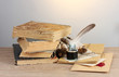 old books, scrolls, feather pen and inkwell