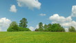 Rural landscape with old house,green field and white clouds
