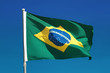 Brazilian flag and pole flutters against Brazil blue skies