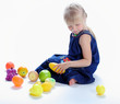 the lovely girl plays with fruit