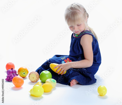 Photo: the lovely girl plays with fruit the lovely girl plays with fruit