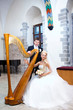 groom and bride with harp in old town hall interior groom and bride with harp in old town hall interior