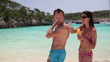 Video: Woman applying sun block lotion on man's back, dolly shot Woman applying sun block lotion on man's back, dolly shot