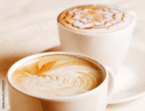 Photo: Coffee cup with artistic cream decoration Coffee cup with artistic cream decoration