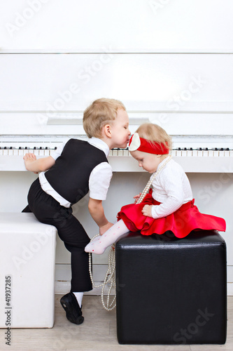 Photo: little children sitting near piano little children sitting near piano