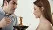 Man and woman having fun and laughing with dish of pasta