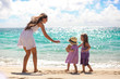 Mother and two kids at beach on sunny day