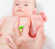 Mother massaging her baby girl