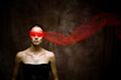 Beauty brunette with red ribbon on eyes