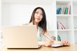 Beautiful young woman using a laptop computer