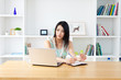 Beautiful young woman using a laptop computer