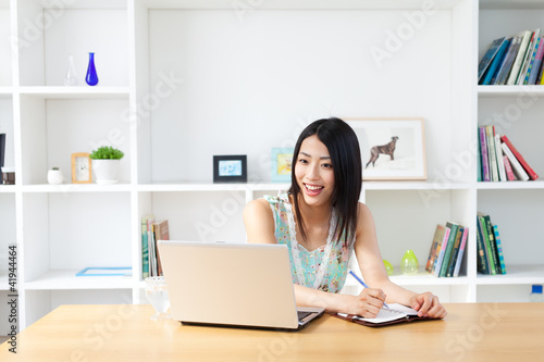 Photo: Beautiful young woman using a laptop computer Beautiful young woman using a laptop computer