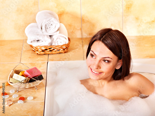 Photo: Woman in bathroom. Woman in bathroom.