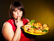 Woman eating hamburger.