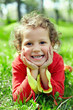 Photo: little girl lying on grass at summer field. a bit dirty hands little girl lying on grass at summer field. a bit dirty hands