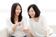 Photo: Beautiful young women using a moblie phone Beautiful young women using a moblie phone