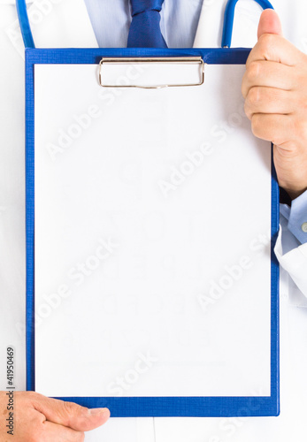 Photo: Doctor showing a white sheet of paper Doctor showing a white sheet of paper