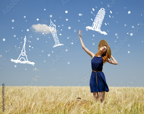 Photo: Redhead girl at spring wheat field. Redhead girl at spring wheat field.