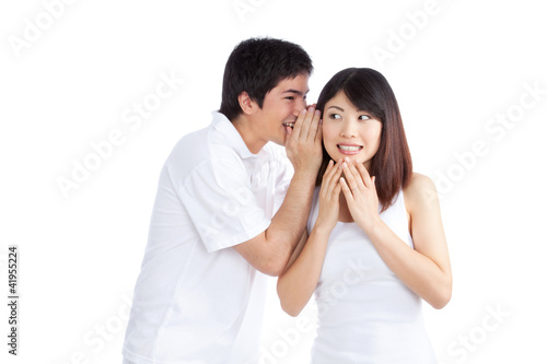 Foto: Man Whispering Woman's Ear Man Whispering Woman's Ear