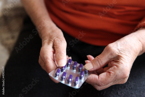 Photo: Close up of old hands with tablets. Close up of old hands with tablets.