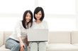 Beautiful young women using a laptop computer. Portrait of asian