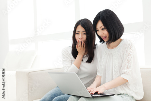 Photo: Beautiful young women using a laptop computer. Portrait of asian Beautiful young women using a laptop computer. Portrait of asian