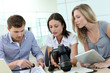 Photo: Team of photo reporters working in office Team of photo reporters working in office