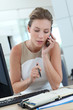 Businesswoman at her desk booking meeting hours on agenda