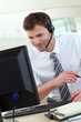 Customer service representative sitting in front of desktop