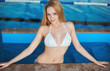 Beautiful young woman at a pool