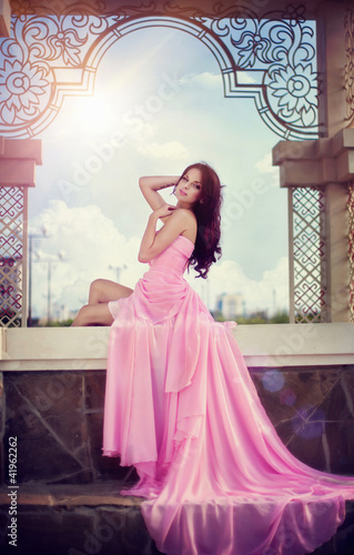 Photo: girl in a long pink dress girl in a long pink dress