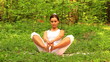 Video: Young woman doing yoga exercise in green park Young woman doing yoga exercise in green park