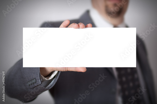 Photo: Businessman showing a blank card Businessman showing a blank card