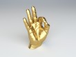 golden hand sculpture making the ok gesture