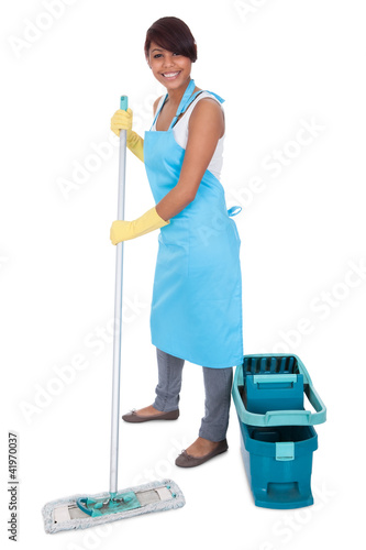 Photo: Cheerful woman having fun while cleaning Cheerful woman having fun while cleaning