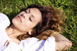 Photo: young woman sleeping laying on the grass young woman sleeping laying on the grass